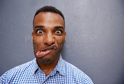 Buy stock photo Goofy, funny and portrait of black man by wall for comic, playful or comedy joke expression. Silly, crazy and face of confident young African male person by gray background with mockup space.