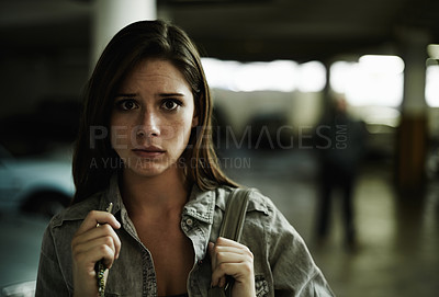 Buy stock photo Woman, suspicious and parking lot with anxiety, worried and stressed for safety and concern. Female person, blur background and scared with backpack, terror and portrait for scary place and in fear