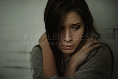 Buy stock photo A young woman looking anxious and fearful