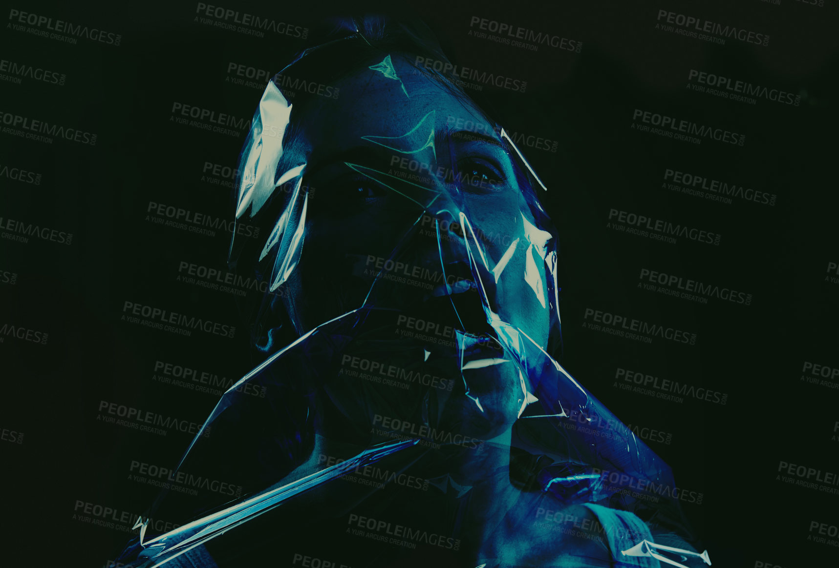 Buy stock photo A young woman suffocating with her head wrapped in plastic while isolated on a black background