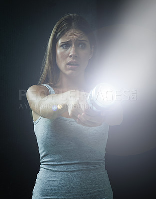 Buy stock photo Woman, fear and horror or flashlight for search in studio, anxiety and stress for risk in mystery. Female person, nervous and lamp in dark against black background, caution and danger on halloween