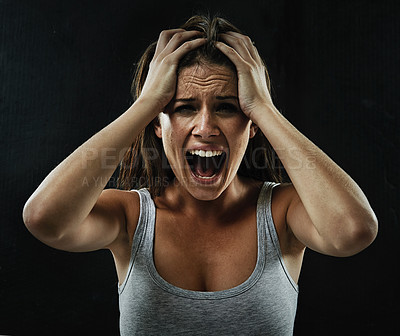 Buy stock photo A young woman screaming uncontrollably while isolated on a black background
