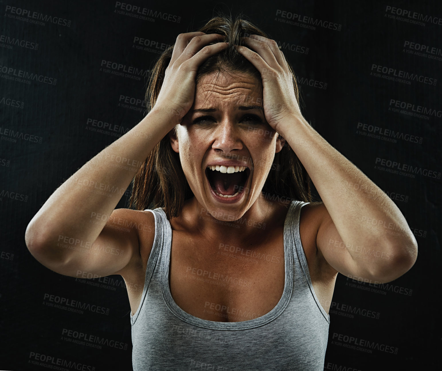 Buy stock photo A young woman screaming uncontrollably while isolated on a black background