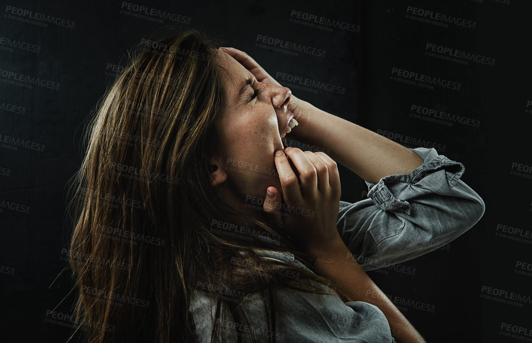 Buy stock photo Profile, stress and horror with woman shouting in studio on black background for reaction to fear. Phobia, anxiety and mental health with scared young person screaming in dark for nightmare or terror
