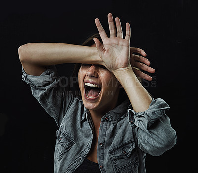 Buy stock photo Hands, stress and horror with woman screaming in studio on black background for reaction to fear. Crazy, anxiety and mental health with young person screaming in dark for drama, nightmare or terror