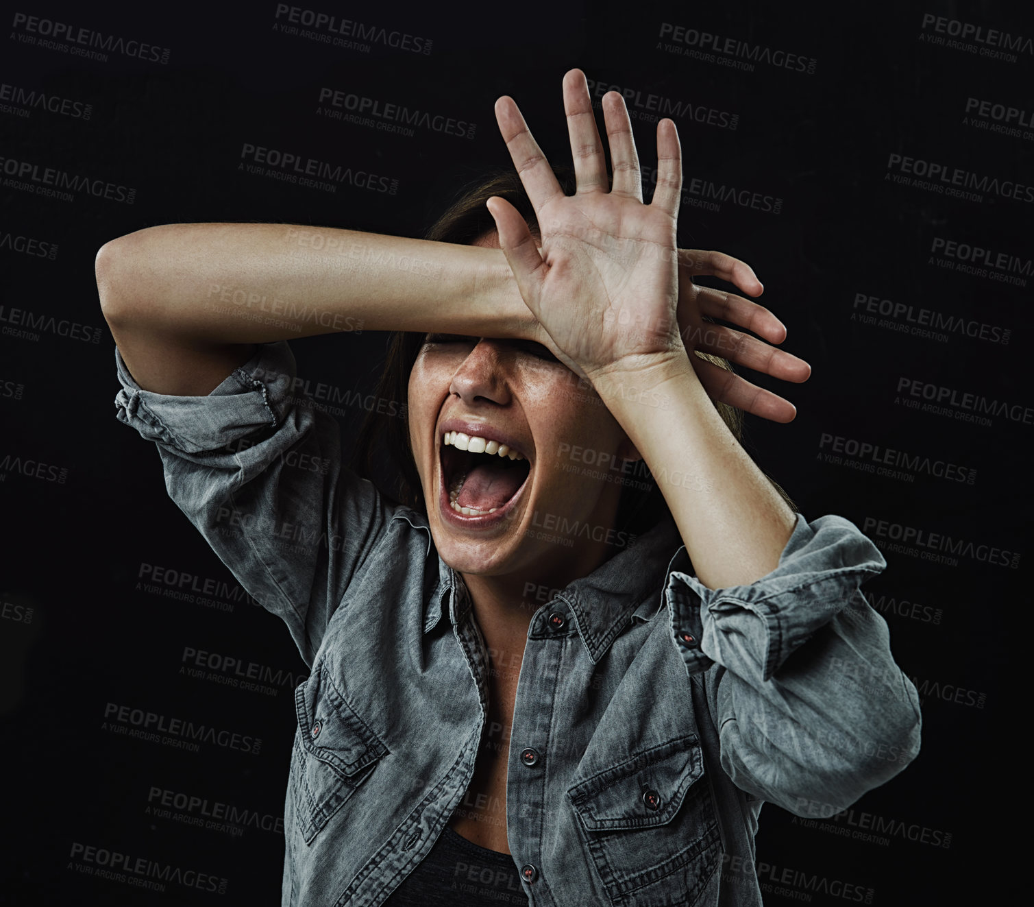 Buy stock photo Hands, stress and horror with woman screaming in studio on black background for reaction to fear. Crazy, anxiety and mental health with young person screaming in dark for drama, nightmare or terror