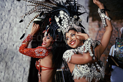 Buy stock photo Shot of two beautiful samba dancers performing in a carnival