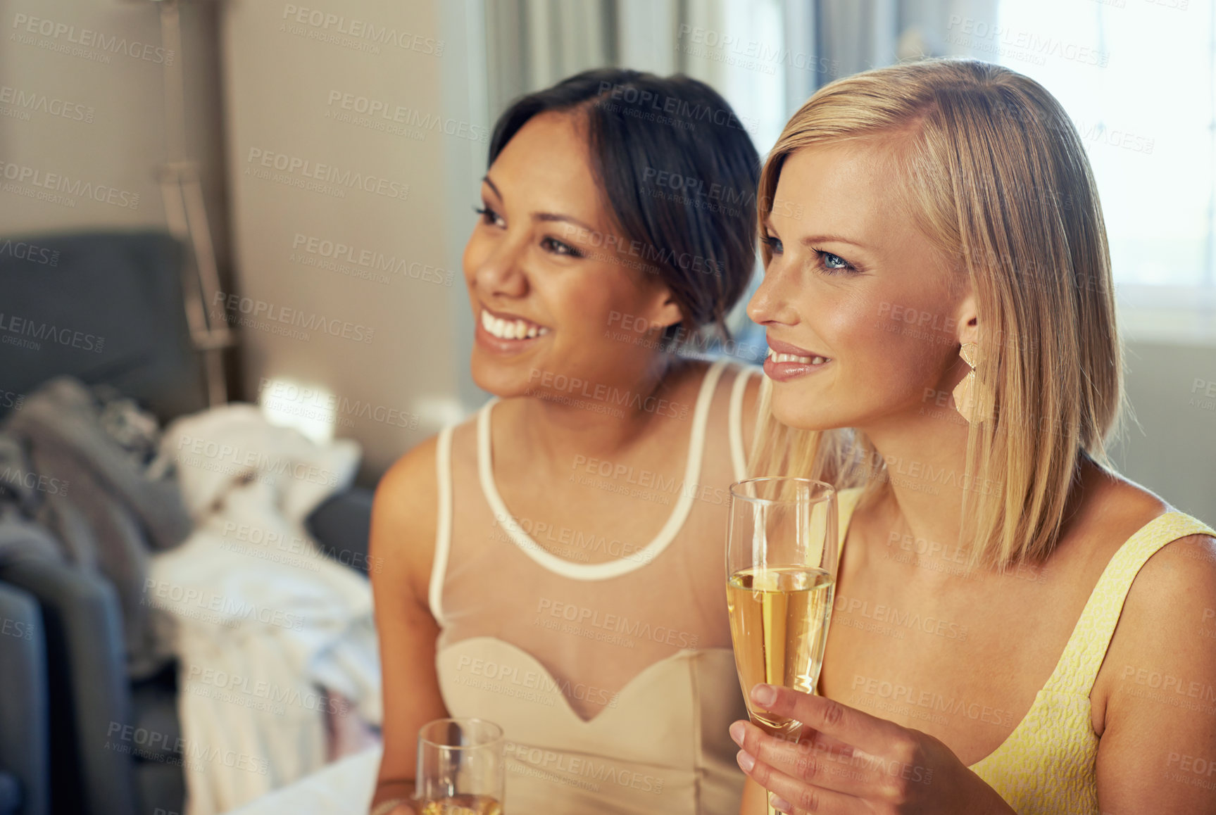 Buy stock photo Young women, champagne and celebration in hotel room as friends, support and fashion to celebrate engagement. Ladies night, bedroom and bubbly glass in elegant clothes and bonding for party event