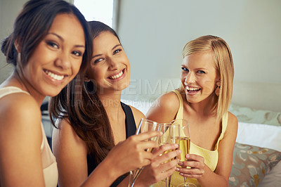 Buy stock photo Portrait of three attractive young women drinking champagne