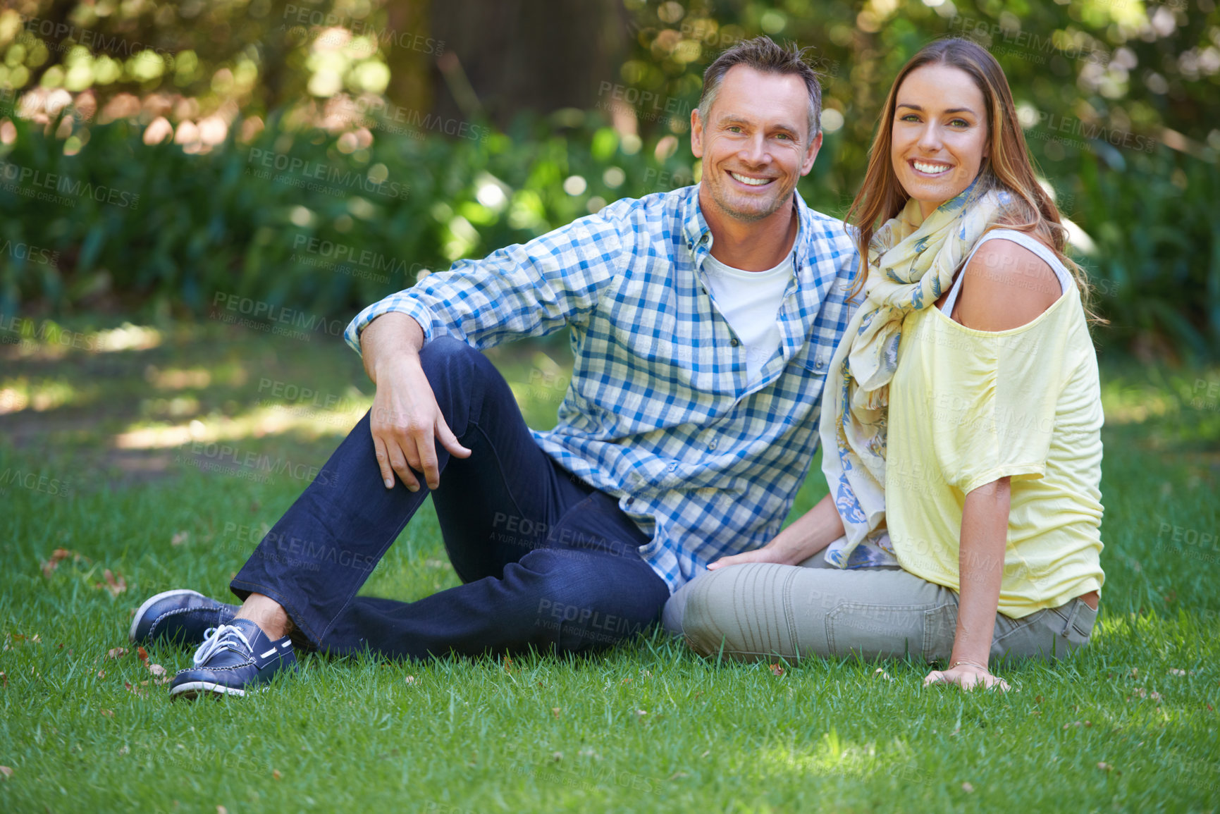 Buy stock photo Portrait, relax and couple with smile on grass for summer romance, trees and fun outdoor date. Love, mature man and happy woman in garden with morning sunshine, park and marriage bonding in nature.