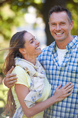 Buy stock photo An affectionate couple outside on a summer's day