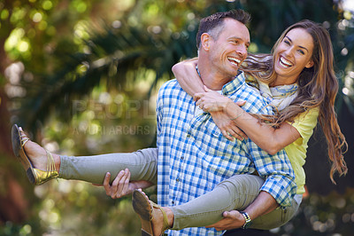Buy stock photo Portrait of an affectionate couple outside in the summer sun