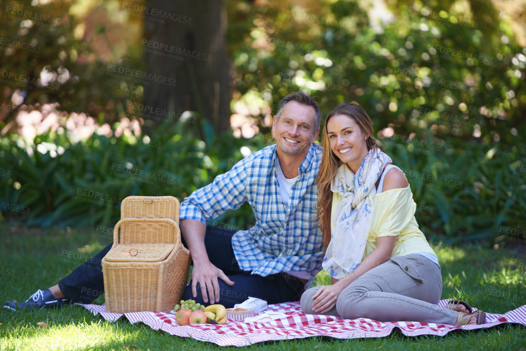 Buy stock photo Portrait, picnic and couple with love, basket and happiness with romance and Valentines day with marriage. Date, man and woman on the ground, relationship or anniversary with celebration or honeymoon