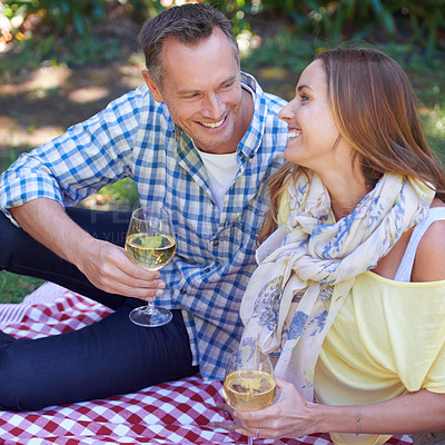 Buy stock photo Couple, picnic and wine for bonding in outdoor nature, love and romance in relationship on weekend. Alcohol, conversation and people on date in countryside, adventure and forest for happy on vacation