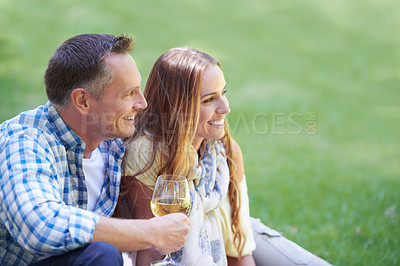 Buy stock photo Couple, travel and wine for bonding in outdoor nature, love and romance in relationship on weekend. Alcohol, conversation and people on date in countryside, adventure and relax on grass for vacation