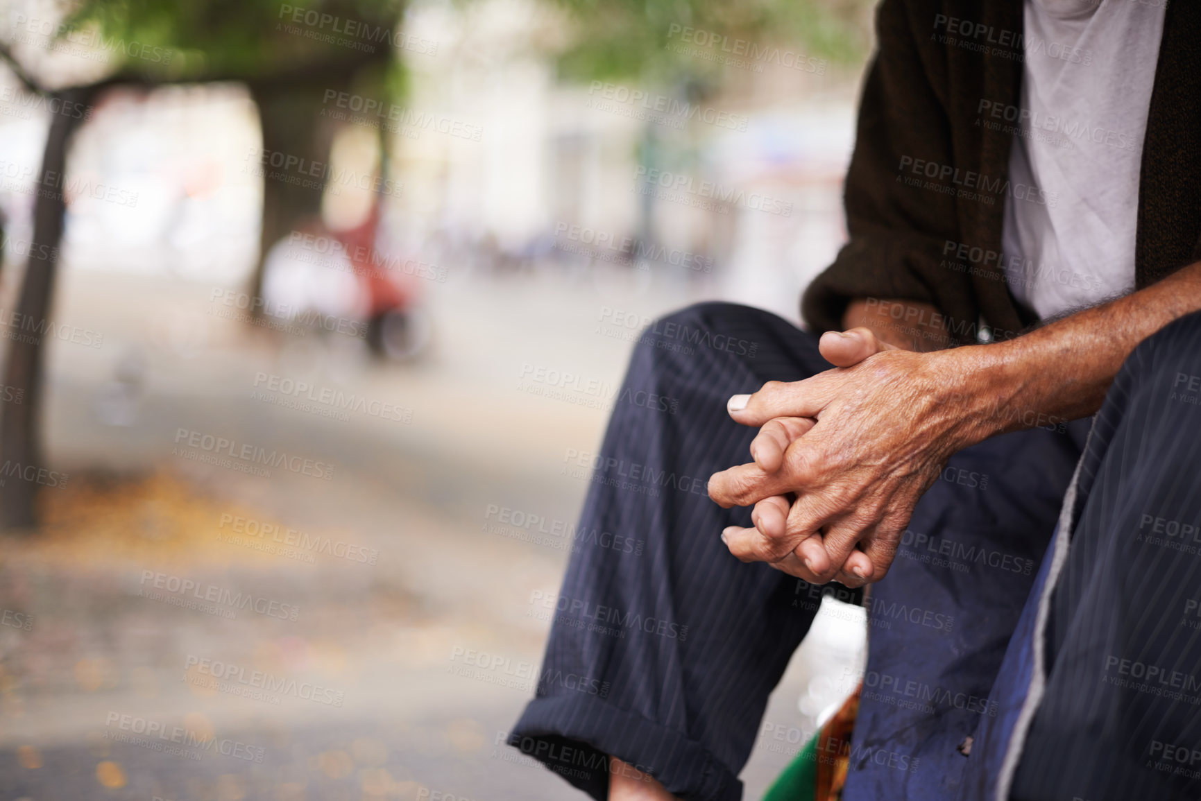 Buy stock photo Cropped shot of an old man sitting outside