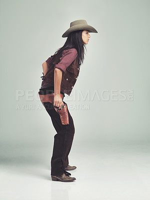 Buy stock photo Woman, cowgirl and weapon in studio, clothing for wild west gun, outfit and halloween costume with holster. Female person, cowboy hat and boots from Texas, white background and dress up like bandit