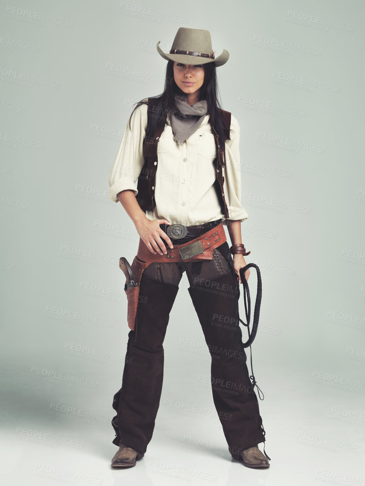 Buy stock photo Woman, cowgirl and portrait in studio for fashion costume with confidence on grey background, weapon or outlaw. Female person, whip and hat with mockup space in Texas for dress up, old west or rodeo