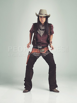 Buy stock photo Full-length shot of an attractive young woman in cowboy attire