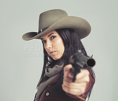 Buy stock photo Woman, cowgirl and portrait or pointing weapon for wild west costume on white background, rodeo or outfit. Female person, revolver and cowboy hat in studio for Texas dress up, confidence or mockup