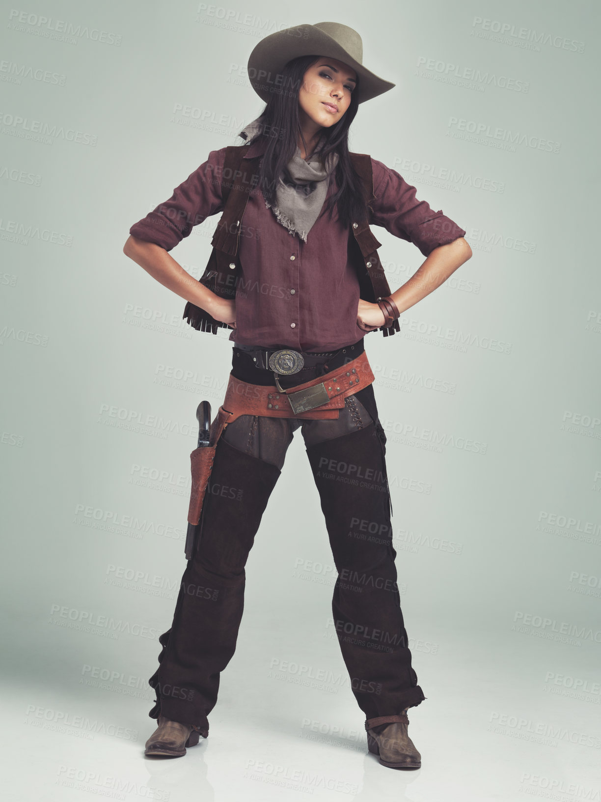 Buy stock photo Woman, cowgirl and portrait in studio for western costume with confidence on grey background, weapon or outlaw. Female person, wild and hat with mockup space in Texas for dress up, old west or rodeo