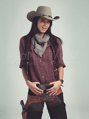 Buy stock photo Cropped shot of an attractive young woman in cowboy attire