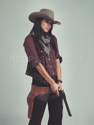 Buy stock photo Woman, fashion and cowboy clothes with gun in studio, western character and costume isolated on white background. Wild west style, pistol for outlaw cosplay and vintage apparel in a portrait
