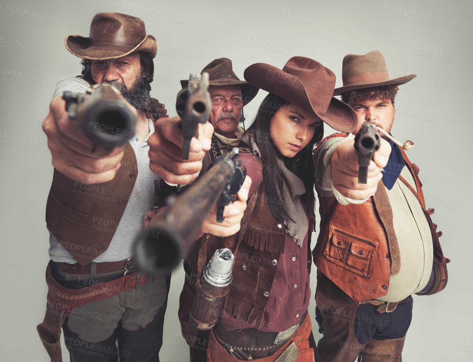 Buy stock photo Western, cowboy and gun with point in studio for wild west, criminal or outlaw on grey background. Band of people, portrait and face with pistol with shoot gesture for aim, weapon or fire with danger