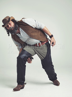 Buy stock photo Portrait, cowboy and character with gun in studio mockup, outlaw and wild west criminal with pistol. Mature texas man, bandit face or weapon to fight or western or revolver trick by white background