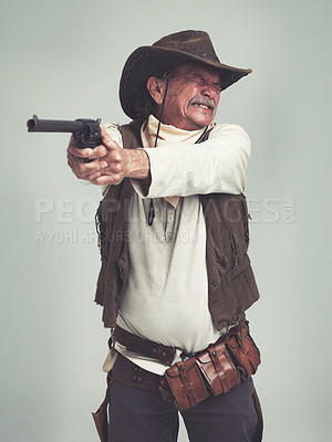 Buy stock photo Cowboy, senior man and shooting gun, weapon or pistol in studio with costume isolated on a white background. Western, sheriff and mature person with revolver, aiming and scared with fear in Texas