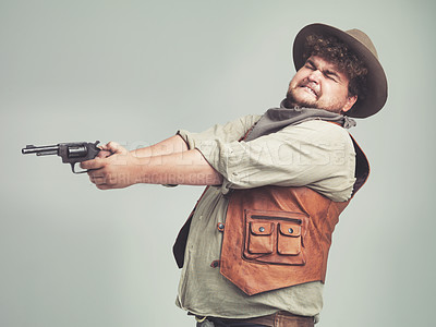 Buy stock photo Cowboy, funny man and shooting gun in studio, weapon and pistol for western fight isolated on a white background. Plus size, criminal and person with revolver, scared or guess aim with fear in Texas