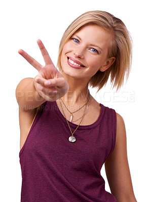 Buy stock photo Studio shot of happy young woman giving the peace sign to the camera isolated on white