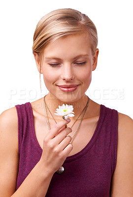 Buy stock photo Studio shot of a young woman smelling a flower isolated on white