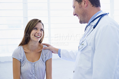 Buy stock photo Doctor, woman patient and good news in a hospital and clinic with medical consultation. Healthcare, wellness and happiness with a young female person and medic worker with communication and support