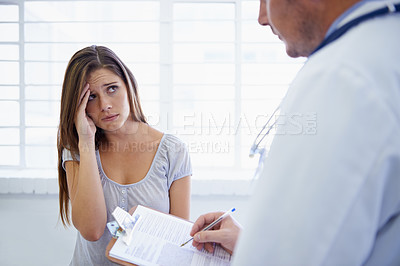Buy stock photo Doctor, woman and consultation or paperwork or worry for diagnosis checklist or results, headache or virus. Patient, healthcare and document in hospital for migraine prescription, test or treatment