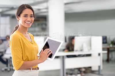 Buy stock photo An attractive businesswoman using a tablet in the office