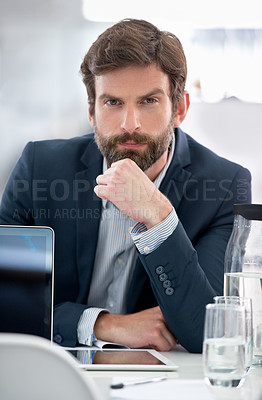 Buy stock photo Portrait of a young businessman sitting at his office desk