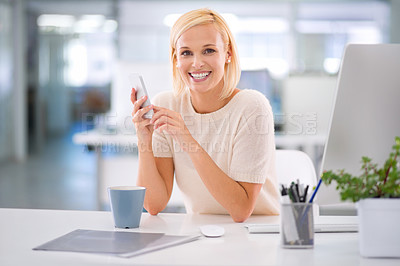 Buy stock photo Cropped shot of a businesswoman using her cellphone at her desk