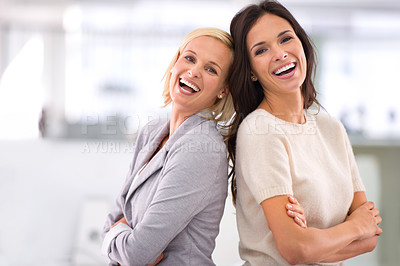 Buy stock photo Portrait of two female coworkers standing together in the office
