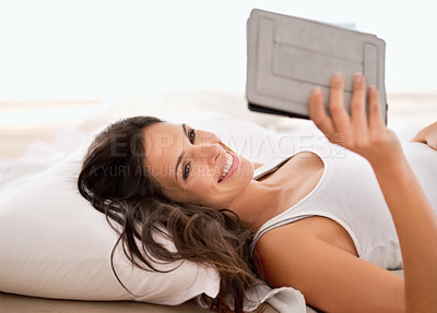 Buy stock photo Woman, tablet and reading in bedroom, morning and story with ebook for knowledge, information or novel. Girl, person and happy to relax in bed with digital touchscreen for streaming app at apartment