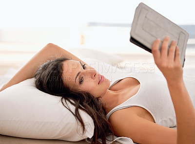 Buy stock photo Woman, tablet and reading in bed, morning and story with ebook for knowledge, information or novel. Girl, person and happy to relax in bedroom with digital touchscreen for streaming app at apartment