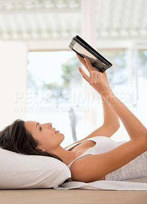 Buy stock photo Woman, ebook and tablet on bed reading, girl and device for online entertainment from home. Browsing and social media communication while relaxing, female person and scrolling for literature novel