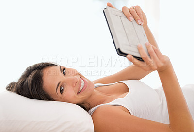 Buy stock photo Woman, tablet and reading in bed, portrait or story with ebook, knowledge or subscription in house. Girl, person and smile with digital touchscreen for streaming app to relax at apartment in morning