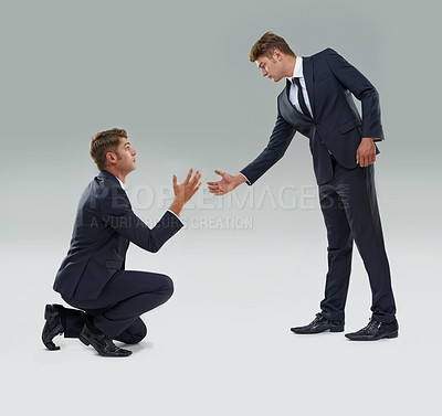 Buy stock photo Assistance, help and teamwork with business man in studio on gray background for aid or support. Collaboration, growth and partnership with young corporate employee giving helping hand to alter ego
