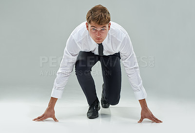 Buy stock photo Portrait, competitive businessman and starting position on studio background to chase deadline, target or deal in business. Male model, corporate person or lawyer in running pose to race or challenge