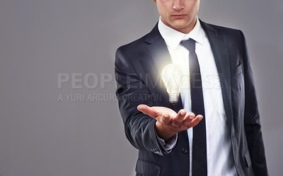 Buy stock photo Business man, light bulb glow and ideas for entrepreneur with innovation and problem solving for energy saving. Hologram, solution and corporate goals for knowledge and power on grey background