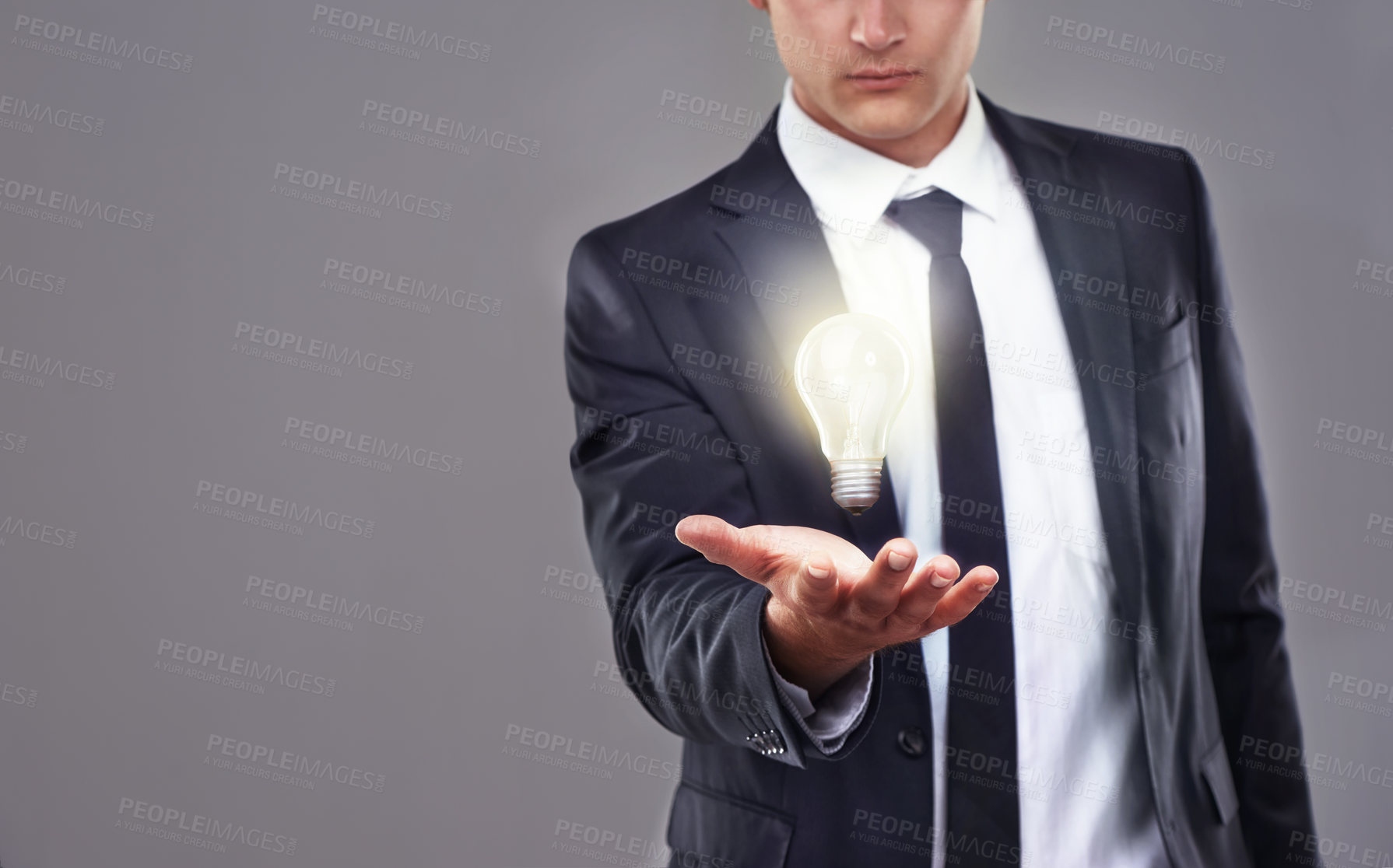 Buy stock photo Business man, light bulb glow and ideas for entrepreneur with innovation and problem solving for energy saving. Hologram, solution and corporate goals for knowledge and power on grey background