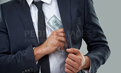 Buy stock photo Cropped image of a businessman putting money in his pocket