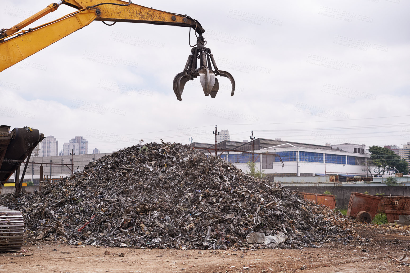 Buy stock photo Cropped shot of an excavator sorting through a pile of scrap metal