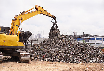 Buy stock photo Cropped shot of an excavator sorting through a pile of scrap metal